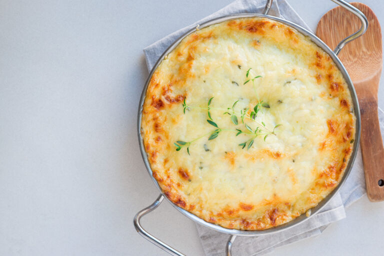 Cheesy scalloped potatoes or potato gratin in baking dish, holid